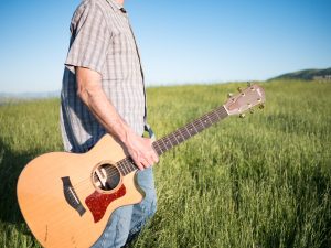 Walking with Guitar at Sunset