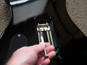 Tightening the springs to clamp the spacer